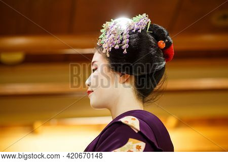 Kyoto, Japan - 18 May, 2015: Maiko Apprentice Showing Japanese Traditional Dance. Maiko Is An Appren