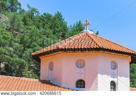 Roofs Of Kykkos Monastery Between Green Trees On A Clear Sunny Day