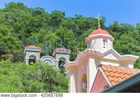 Roofs Of Kykkos Monastery Between Green Trees On A Clear Sunny Day