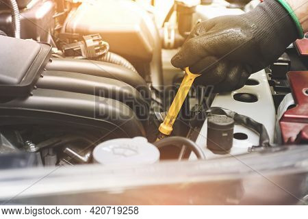 Mechanic Hand Was Pulling Oil Dipstick To Lube Level Checking Of Engine Car