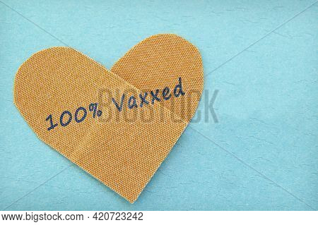 Bandage In A Heart Shape With 100% Vaxxed Text -- Covid-19 Coronavirus Vaccine Concept