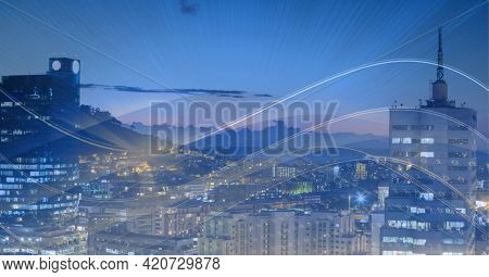 Composition of digital light trails over cityscape. global data processing and digital interface concept digitally generated image.