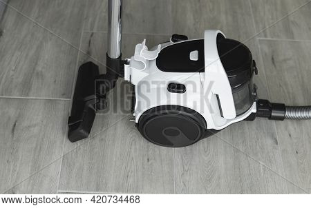 Bagless Cyclone Vacuum Cleaner On A Grey Tile. Electrical Apparatus That By Means Of Suction Collect