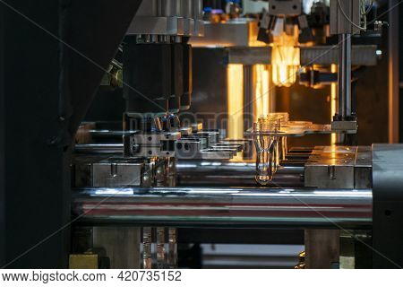 The Preform Shape Of Pet Bottle In The Blowing Mold Machine. The Operation Of Pet Bottle Processing 