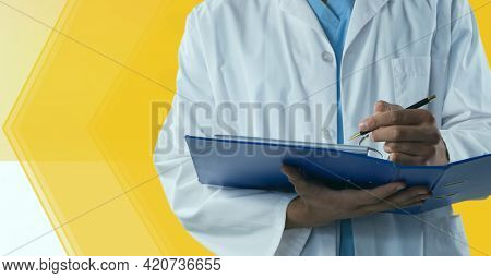 Composition of midsection of male doctor in lab coat writing holding file. medicine and healthcare services concept digitally generated image.