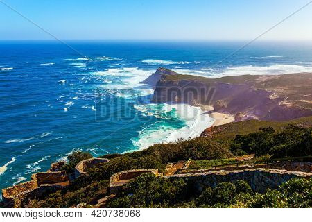 South Africa. Powerful ocean surf. Cape of Good Hope at the southern tip of the Cape Peninsula. White foam of the ocean surf. Bird's-eye view. Bright sunny summer february day