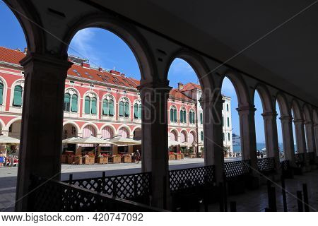 Split, Croatia - July 20, 2019: People Visit Shaded Arcades Of Prokurative Building At Trg Republike