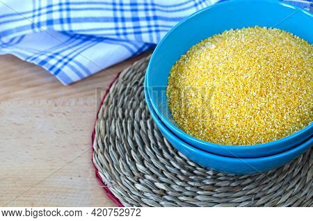 Corn Grits In A Blue Cup On A Round Wicker Stand