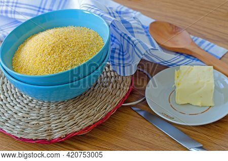Corn Grits In A Blue Cup On A Round Wicker Stand