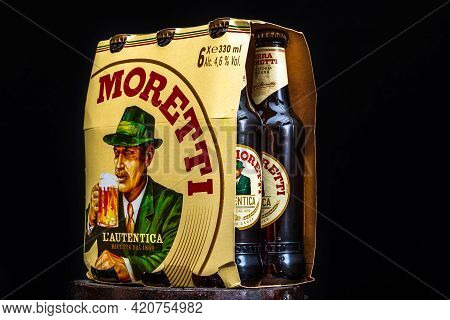 6 Pack Of Birra Moretti Beer On Wooden Barrel With Dark Background. Illustrative Editorial Photo Buc