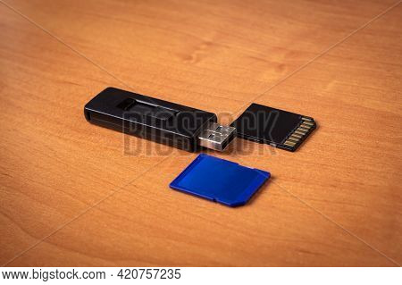 Flash Drive. Memory Card.wood Background.memory Drives On The Table