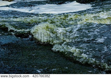 The Texture Of Water On The Surface Of A Small Waterfall In The Ukrainian Steppe Close-up. Tokovsky