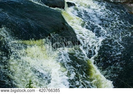 The Texture Of Water On The Surface Of A Small Waterfall In The Ukrainian Steppe Close-up. Tokovsky