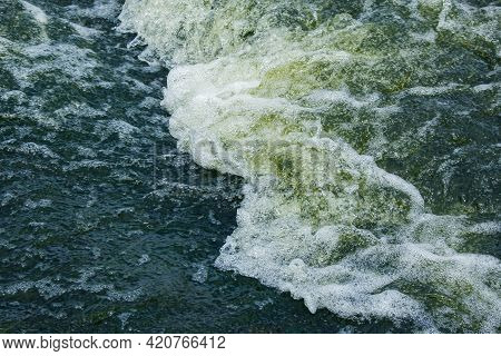 The Texture Of Water On The Surface Of A Small Waterfall In The Ukrainian Steppe Close-up. Tokovsky
