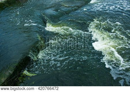 The Texture Of Water On The Surface Of A Small Waterfall In The Ukrainian Steppe Close-up. Tokovsky