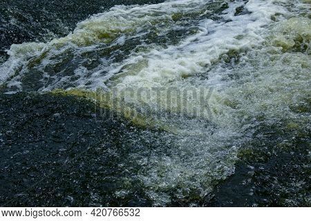The Texture Of Water On The Surface Of A Small Waterfall In The Ukrainian Steppe Close-up. Tokovsky