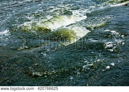 The Texture Of Water On The Surface Of A Small Waterfall In The Ukrainian Steppe Close-up. Tokovsky