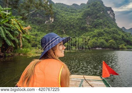 Woman Tourist In Trang An Scenic Landscape Complex In Ninh Binh Province, Vietnam A Unesco World Her
