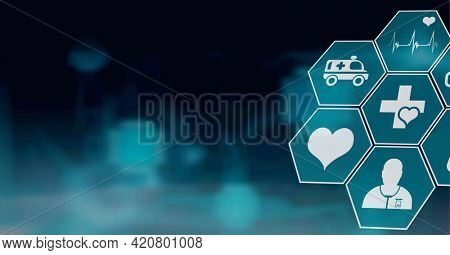 Composition of network of medical icons on hexagons over glowing blue background. global science, medicine and research concept digitally generated image.