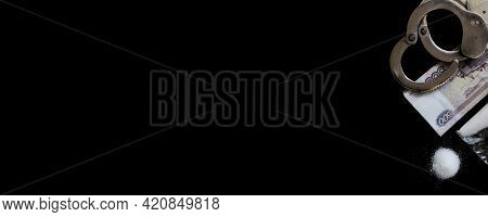 Handcuffs On A Bundle Of Ruble Banknotes (russion Money) And Cocaine, Black Background. Long Banner.
