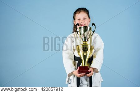 Knockout. Energy And Activity For Kids. Winner Little Girl In Gi Sportswear. Small Girl With Champio