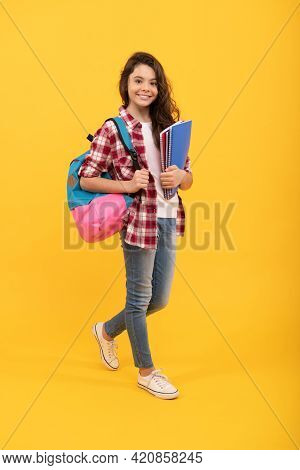 Happy Girl Back To School Carrying Books And Backpack Yellow Background, School