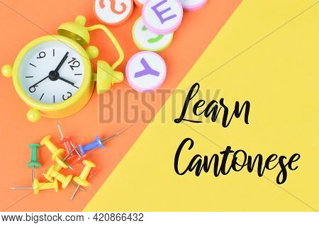Top View Of Clock, Alphabet Letters And Pinboards Over Yellow And Orange Background Written With Lea