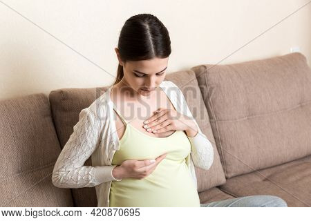 Pregnant Girl Checks Her Breasts. Prevention Of Breast Cancer