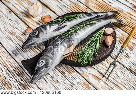 Raw Whole Icefish With Herbs. White Wooden Background. Top View