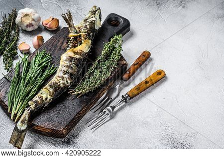 Cooked Mackerel Icefish On A Wooden Cutting Board. Black Background. Top View. Copy Space