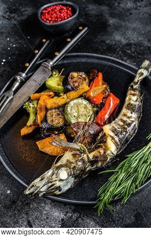 Baked Whole Icefish With Grilled Vegetables. Black Background. Top View