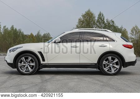 Novosibirsk, Russia - May 16, 2021: White  Infiniti Qx, Side View.  Photography Of A Modern Crossove