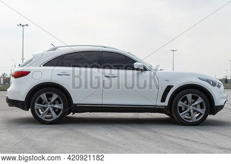 Novosibirsk, Russia - May 16, 2021: White  Infiniti Qx, Side View.  Photography Of A Modern Crossove