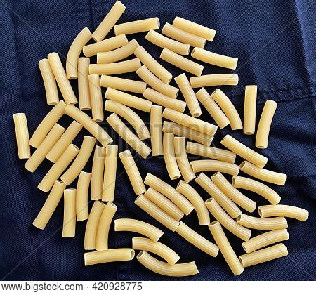 Raw Italian Maccheroni. Italian Traditional Pasta On Dark Background.