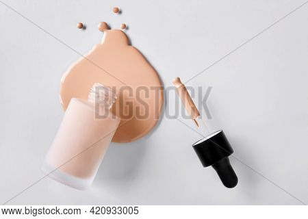 Spilled Liquid Foundation. Mockup Glass Bottle Of Correction Cosmetic Product With Pipette. Beauty B