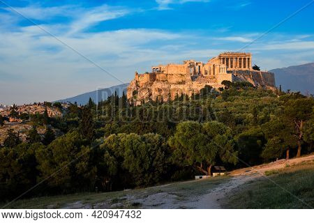 Famous greek tourist landmark - the iconic Parthenon Temple at the Acropolis of Athens as seen from Philopappos Hill on sunset. Athens, Greece