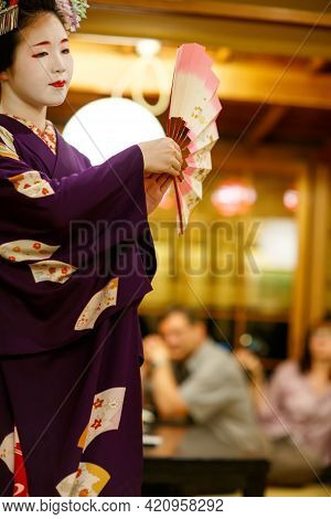 Kyoto, Japan - 18 May, 2015: Maiko Apprentice Showing Japanese Traditional Dance. Maiko Is An Appren