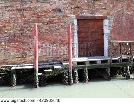 Mooring To Moor Ships In A Navigable Canal In The Italian Island