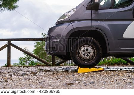 Camper Leveling Yellow Block In Use. Leveler Ramp Chock Blocks For Rv Travel Trailer. Accessories Fo