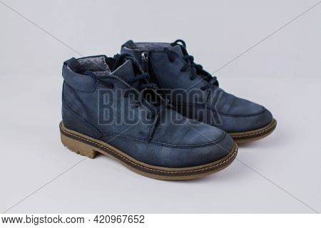 A Winter Blue Boots On A White Background