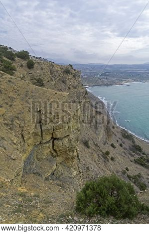 The Steep Slope Of Cape Alchak. Sudak, Crimea. Cloudy Day At The End Of April.