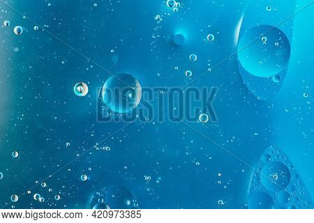 Oil With Bubbles On Dark Blue Background. Abstract Space Background. Soft Selective Focus. Macro Of 