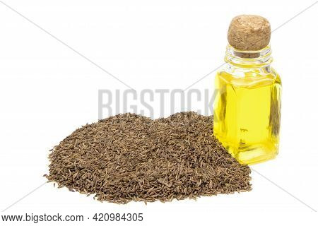 Cumin Essential Oil. Glass Bottle Of Cummin Oil. Caraway In A Sack Of Isolated On A White Background