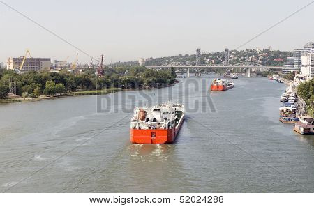 Multi-colored Ships Pass Under The Drawbridge