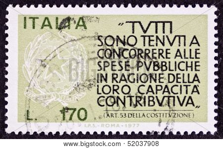 ITALY - CIRCA 1977: a stamp printed in Italy celebrates  Italian Fiscus showing an article of Italian Constitution about obligation to contribute. Italy, circa 1977