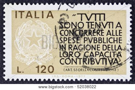 ITALY - CIRCA 1977: a stamp printed in Italy celebrates  Italian Fiscus showing an article of Italian Constitution about obligation to contribute. Italy, circa 1977