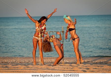 Vacationers have fun doing the limbo