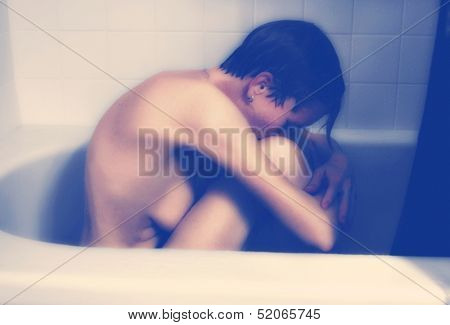 a very depressed person in the bathtub