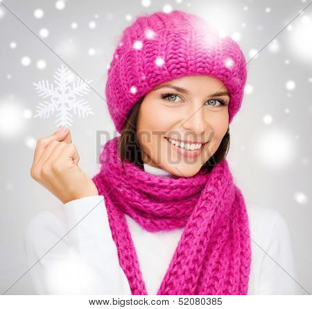 winter, people, happiness concept - woman in hat and muffler with big snowflake