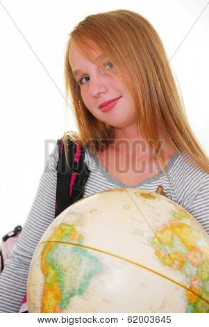 Young smiling girl with a backback and a globe isolated on white background